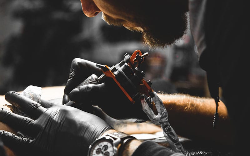 Tattoo artist working in tattoo studio